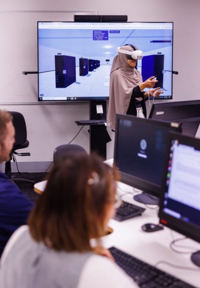 A Victoria University student wearing a VR headset explores a simulated data centre in FacilityVR at the Microsoft Datacentre Academy